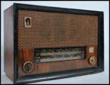 A vintage 1940's walnut cased Cossor Melody Master 523 valve radio with decorative dial and facia