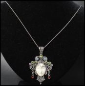 A 925 silver Art Nouveau style pendant necklace strung with figural pendant of a lady set with