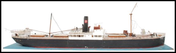 A vintage 20th century scratch built model of a coastal tanker raised on a water effect