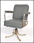 A vintage retro mid 20th century industrial office swivel chair of tubular construction raised on