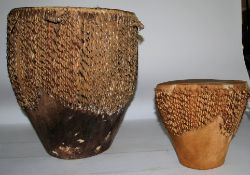 A vintage 20th century African tribal animal hide and hair drum with skin top and bottom stretched