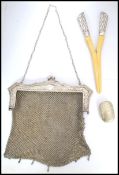 An Edwardian silver white metal mesh evening bag,  fine mesh work square bag below reticulated