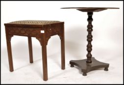 An Edwardian piano stool with hinged led raised on square legs with blind fret worked detailing