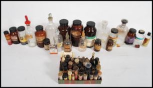 A collection of vintage mid 20th century glass apothecary bottles of various signs and form, some