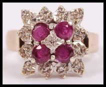 A 9ct gold and diamond ring ruby ring in a cluster setting with a halo of illusion set diamonds