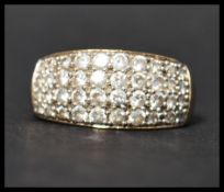 A hallmarked 9ct gold and CZ ring having pave set CZ in a domed mount. Hallmarked Sheffield.