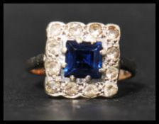 A 9ct gold sapphire and white stone rig set with a square cut blue sapphire surrounded by a halo