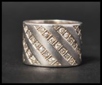 A hallmarked 925 silver band ring set with clear stones. Size K.5. Weight 7g.