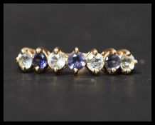 A hallmarked 9ct gold set with 7 white and purple alternating stones. Hallmarked Birmingham. Size