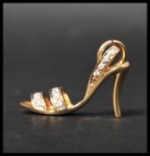 A hallmarked 18ct gold and diamond charm in the form of a stiletto shoe set with 17 diamonds to