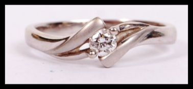 An 18ct gold and diamond crossover ring approx 15pnts of diamonds with weight of 3.8g