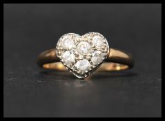 A hallmarked 9ct gold and CZ ring with 6 round cut CZ in a heart shaped mount. Hallmarked Sheffield.