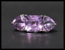 A hallmarked 9ct white gold ring set with purple stones. Hallmarked Birmingham.  Weight  4.1g.  Size