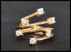 A  contemporary hallmarked 9ct gold and CZ ring with split shoulders and scatter setting. Hallmarked