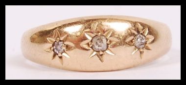 An antique 18ct gold  and diamond gypsy setting ring having 3 star set diamonds approx 3.3g weight /