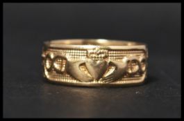A hallmarked 9ct Gold Claddagh band ring inscribed  