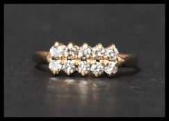 A hallmarked 9ct gold and CZ ring having 10 round cut CZ in a pave setting. Hallmarked Edinburgh.