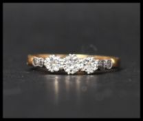 A hallmarked 18ct gold platinum and diamond three stone ring set with three illusion set diamonds