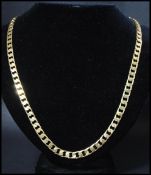 A hallmarked 9ct gold flat curb link chain necklace having a lobster claw clasp. Hallmarked