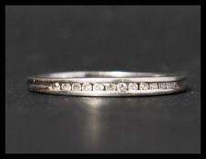 A hallmarked 9ct white gold and diamond half eternity ring having 13 suspension set diamonds in a