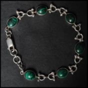 A 925 silver bracelet set with malachite cabochons having a lobster claw clasp. Marked 925. Measures