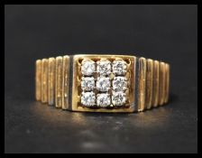 A hallmarked 18ct yellow and white gold and diamond ring having white and yellow gold stylised