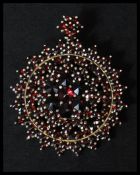 A 925 silver vermeil bohemian garnet pendant brooch having a roller clip clasp and garnet cluster