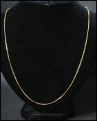 An18ct gold chain necklace with spring hoop clasp. Marked 750, tests 18ct gold. Measures 22