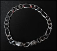 A hallmarked 925 silver Figaro chain bracelet with panther head finial clasp. Measures 7.5 inches.