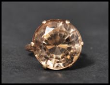 A vintage 9ct gold dress ring set with a large round cut smokey quartz. Marked 9ct, tests 9ct