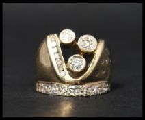 An unusual 9ct gold and diamond ring with illusion, channel and bezel set diamonds in the