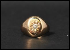 A Victorian hallmarked 18ct gold and diamond signet ring having a single diamond set in a star cut