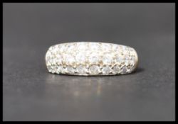 A hallmarked 9ct gold and CZ ring having ribbed shoulders and pave set CZ. Hallmarked Sheffield.