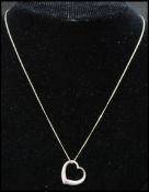 A 925 pendant necklace strung with a heart pendant. Marked 925. Measures 18 inches.
