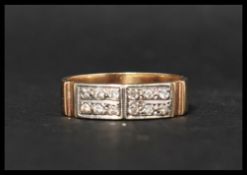 A hallmarked 9ct gold and diamond pave set band ring, set with 12 diamonds . Hallmarked
