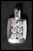 A hallmarked 9ct white gold and CZ pendant having 6 CZ in a pave setting. Hallmarked Birmingham.