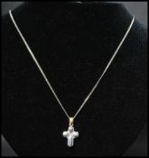 A hallmarked 18ct gold and diamond necklace strung with a white and yellow gold diamond set crucifix