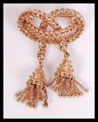 A 9ct gold ladies brooch of unusual form having cross over design with drop finials. Total weight