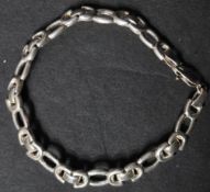 A hallmarked 925 silver bracelet having pierced links with a lobster claw clasp. Hallmarked