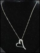 A 925 pendant necklace having a heart pendant with clear stones. Marked 925. Measures 18 inches.