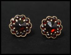 A pair of 14ct gold and bohemian garnet cluster earrings with post backs and butterfly fasteners.