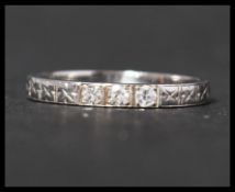 An 18ct white gold and diamond band ring set with three old cut diamonds in a star cut band.