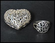 A hallmarked London 925 silver heart pendant having a pierced foliate design together with a similar