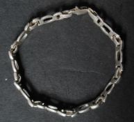 A 925 silver bracelet with swirl inks and lobster claw clasp. Marked 925. Measures 7.25 inches.