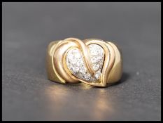 A hallmarked 18ct gold and white stone Italian designer dress ring. The ring decorated with a