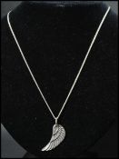 A silver 925 pendant necklace strung with an angel wing feather pendant. Marked 925 Silver Sevre.