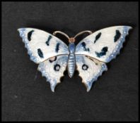 A hallmarked silver and guilloche enamel brooch pin in the form of a butterfly. Hallmarked