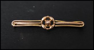 An Edwardian 9ct gold bar brooch with rose motif and c clasp. Marked 9ct, tests 9ct gold. Measures