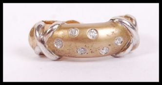 A pair of 18ct gold and diamond earrings of half creole form with studs. Total weight 3.3g