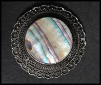 A vintage abalone and silver brooch pendant pin. Marked Jerusalem ST 900. Measures 5cms.